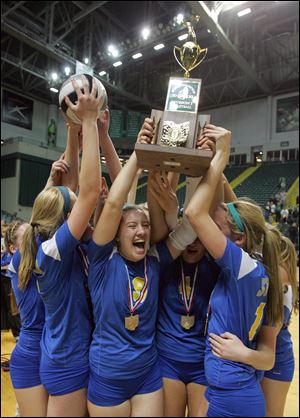 Veronica Zimmerman and her teammates celebrate St. Ursula's victory over Dublin Coffman to claim the Division I state volleyball championship. 