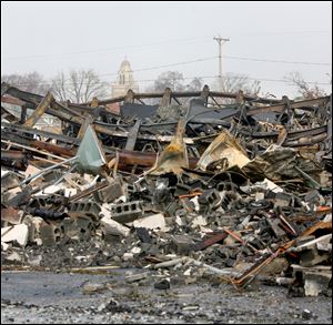 Fire officials suspect arson was the cause of the fire that destroyed a former North Toledo bowling alley and night club. Crews leveled the building Saturday.
