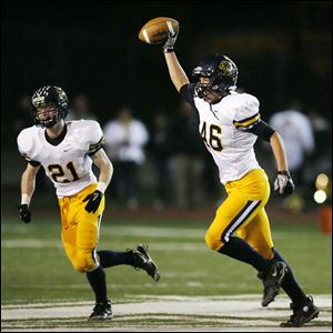 Whitmer linebacker Michael Bodi celebrates recovering a fumble with Joe McNabb in a Division I regional semifinal against Twinsburg in Ashland. 
