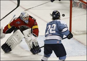 The Walleye's Scooter Smith watches his shot sail wide of the net past Cincinnati goalie Chet Pickard.
