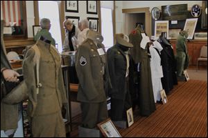 Uniforms stand at attention among other military items at the Oregon Jerusalem Historical Society museum's renovated room that opened on Veteran's Day.