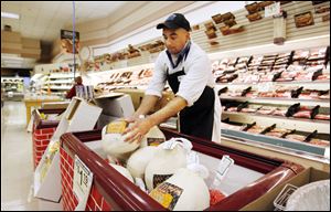 Meat manager Chuck Kiess adds more turkeys to the freezer on the floor at Walt Churchill's Market in Perrysburg.
