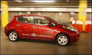 The Nissan Leaf, a 100% electric car, zero emissions vehicle, is test driven at the 2010 Los Angeles Auto Show. 