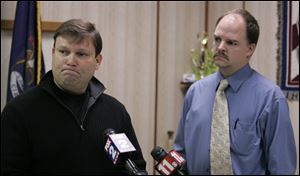 Andy Arena, FBI special agent for Michigan, left, and Morenci police chief Larry Weeks, talk about the investigation of the missing Skelton children in Morenci, Michigan Sunday.