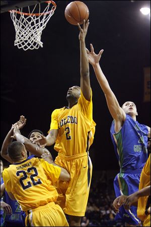 UT's Delino Dear puts up a shot against the defense of Florida Gulf Coast's Charlie Lytle, right, during the first half at Savage Arena. 

