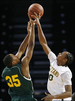 Start's Maurice Taylor, right, tips away a shot by John Hay's Chaz Rollins. Taylor was one of three Spartans to score 10 points.
<br>
<img src=http://www.toledoblade.com/graphics/icons/photo.gif> <font color=red><b>VIEW GALLERY:</b></font> <a href=