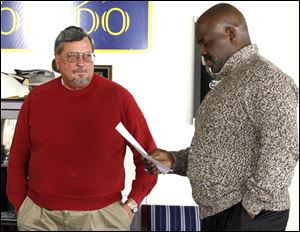 Steve Herwat, deputy mayor of operations, confers with Mike Bell in the mayor's office. Mr. Bell says his popularity among residents is strong even after proposing water and sewer rate increases and pushing through the trash fee increase. 