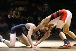 Cody Pontious of Wauseon, right, battles Zach Walker of Napoleon in the 112-pound championship match at the Perrysburg Invitational Tournament. Pontious, who is 17-4 this season, won the title with a 7-0 victory.