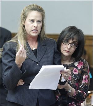 Lisa Bucher, left, mother of Casey Bucher, is embraced by Areti Tsavoussis, executive director of the victim witness assistance program, while addressing the court at the sentencing of her son's killer. 