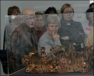 Marion and Ellen Steiner of Temperance, at front and center, tour the Aminah Robinson exhibit at the Glass Pavilion of the Toledo Museum of Art. Marion has memory loss and is touring with others who have the same difficulty.
