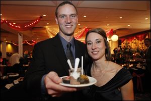 Casey and Aileen Meyer show off some of the desserts at the Junior League of Toledo's Chocolate Soiree. <br><img src=http://www.toledoblade.com/graphics/icons/photo.gif> <font color=red><b>PHOTO GALLERY:</b></font> ON THE TOWN: <a href=