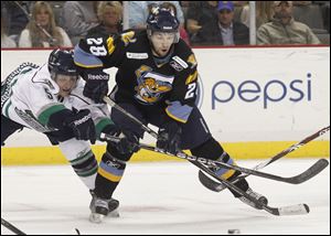 The Walleye's Mike Hedden (28) battles Florida's Bobby Raymond for the puck during the first period at the Huntington Center. 