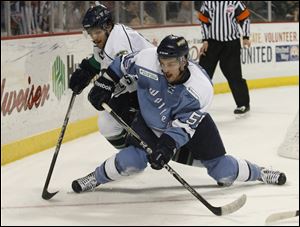 Florida's Francis Lemieux, left, and Toledo's Sebastien Piche chase the puck in the second period.