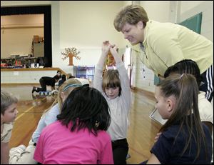 Walbridge Elementary physical education teacher Shelli Smith leads a class that involves relay racing, problem-solving, and cooperative learning.