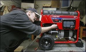 Mechanic Bill Griffith works on a generator at Janney's Service Center in Toledo. Employees have been busy fixing snow-related devices since the start of February.