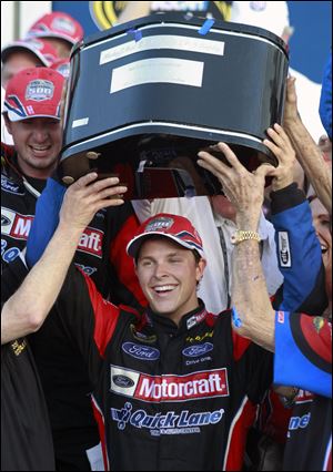 Trevor Bayne raises the trophy after winning the Daytona 500.