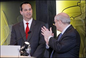 Dean Monske, left, deputy mayor for external affairs, is introduced by David Waterman of the partnership board downtown. Mr. Monske was key during the recent talks with Chinese developers.