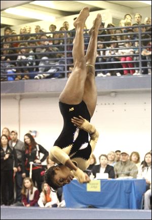 Perrysburg's Chelsea Williams, winner of the vault and uneven bars events, competes in the floor exercise at the gymastics district.