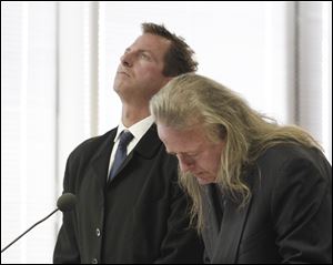 While attorney Adrian Cimerman takes notes, Greg Kreuz, 39, left, listens as Judge Alan Mayberry lectures Kreuz during his sentencing in Wood County County Common Pleas Court. 