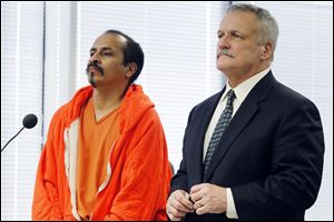 Juan Mendoza, 40, who is Cory Mendoza's uncle, and his attorney, Scott Hicks, attend the hearing.
