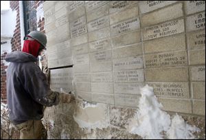 

Darrell Paterson of Spartan Construction replaces the cornerstone of Warren AME Church on Collingwood Boulevard. The time capsule from 1864 was not behind the stone.