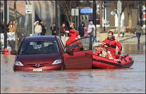 Findlay firefighters pull an unidentified man from his car in Findlay.