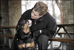 Mona Guinaugh was given responsibility of Darby by Planned Pethood Inc., as a foster parent after the dog suffered a foot-long chemical burn on its back. Miss Guinaugh said Darby is 'a wonderful dog and so gentle.' When the foster period ended she adopted the Rottweiler.
