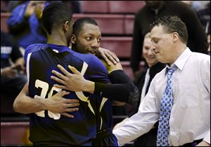 Chester McFadden, left, Leroy Alexander and coach Tim Reiser celebrate Springfield's sectional title. The Blue Devils face St. John's Thursday night.