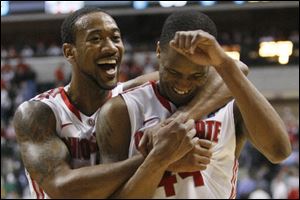 Former Libbey High School and current Ohio State Buckeye William Buford, right, walks off the court with OSU teammate David Lighty.