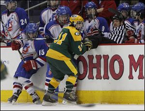Toledo St. Francis de Sales players Kasey Rupp, 15, and Jake Wawrzyniak, 13, battle for the puck with Lakewood St. Edwards player Alex Norton, 11, as an official is knocked into the Kights bench during the first period at Nationwide Arena, Sunday, March 13, 2011. THE BLADE/ANDY MORRISON  15 13 11