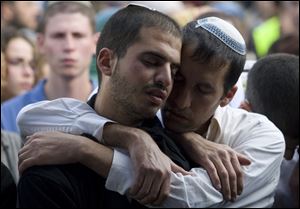 Relatives mourn the Fogel family at their funeral in Jerusalem. Israel launched raids and had 20 suspects in custody for the killings of the West Bank settlers.