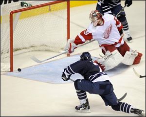 Nashville defenseman Jonathon Blum (7) slips the puck past Detroit s goalie Jimmy Howard (35) for a power play goal in the third period.