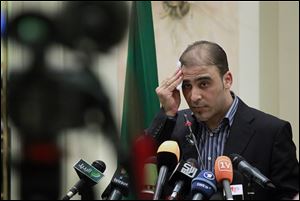 Libyan spokesman Ibrahim Musa stops after reading a letter to President Obama by Muammar Kaddafi.