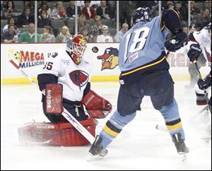 South Carolina goalie Shane Owen, left, stops Toledo's Randy Rowe in a 3-1 Walleye loss. Owen frustrated Toledo with 35 saves.