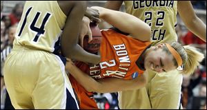 The Falcons' Jennifer Uhl battles LaQuananisha Adams for the ball. The Yellow Jackets frustrated and pressured Bowling Green all day.