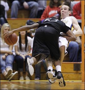 Archbold's Luke Kammeyer is run down by Columbus Africentric's Fuquan Tucker in the Division III regional final.