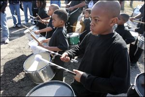 Jameion Capps, 11, and others with the JJ Express Drill and Drum corps. perform at the rally with Bill Cosby at Smith Park.   