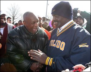 Bill Cosby and Mayor Mike Bell share a laugh outside the Mott Branch Library on Dorr Street. Mr. Bell obeyed Mr. Cosby's request to speak about libraries' importance.