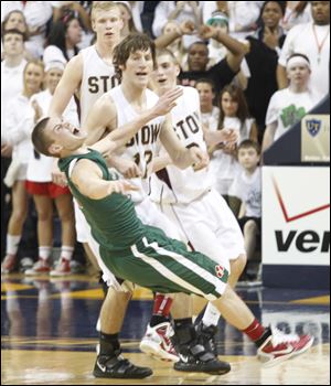 Central’s Drew Lehman grimaces after colliding with Stow-Munroe Falls’ Michael Greenwell at Savage Arena. Lehman scored 15 points as the Irish improved to 20-4 on the season.