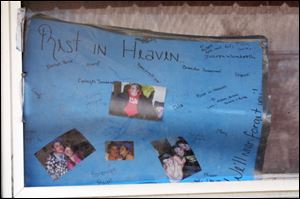 A sign in the window of 1319 Hamilton St. depicts the family and the grief their families and friends are feeling. Neighbors acknowledged that Tamara McDaniel had it tough, but she was there for her kids.