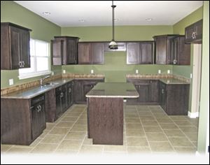 This spacious kitchen boasts a large, granite-topped island, which can double as a snack bar.