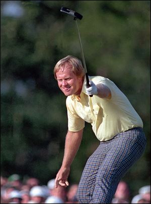 Jack Nicklaus raises his putter in triumph as his birdie putt on the 17th hole at Augusta falls in the cup during the 1986 Masters. The putt capped a dramatic rally that earned the 46-year-old Nicklaus his 18th major championship.
