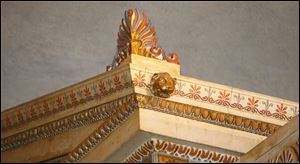Large palmette ornaments top the porticos. The ornaments were used in Greece on the four corners of a roof to cover wooden ridge beams.