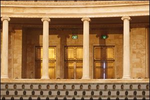 Seating capacity is 1,742, including 1,500 fixed seats on the main floor and seven raised sections. The rest are straight-back chairs behind the row of 28 Iconic columns.