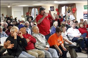 David DeMoss, president UAW Local 1435, stands up and yells 