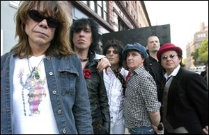 The New York Dolls, shown in 2006, are, from left, David Johansen, Sami Yaffa, Steve Conte (ruffled shirt), Sylvain Sylvain, Brian Delaney, and Brian Koonin.