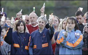 In this file April 10, 2010 file photo, people from the coal mining towns along the Coal River participate in a memorial vigil in Naoma, W.Va., for 29 miners who died in the explosion at Massey Energy Co.'s Upper Big Branch mine in Montcoal, W.Va. 