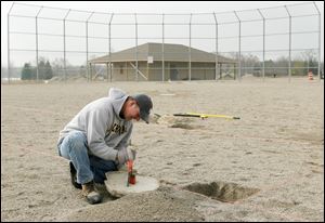 John Jacobs of the Whiteford Rec Board works on the bases.