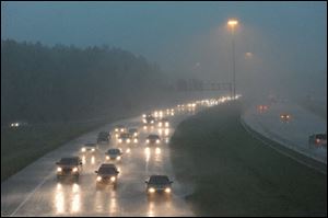Motorists traveling Interstate 55 south at Fortification Street on Monday get pelted by heavy rain from the west as a line severe weather, bringing with it tornado warnings, moves through the metro area in Jackson, Miss.