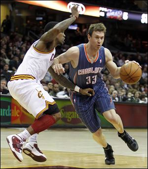 Charlotte Bobcats' Matt Carroll, right, drives around Cleveland Cavaliers' Daniel Gibson in the fourth quarter in Cleveland. The Cavaliers won 99-89. 